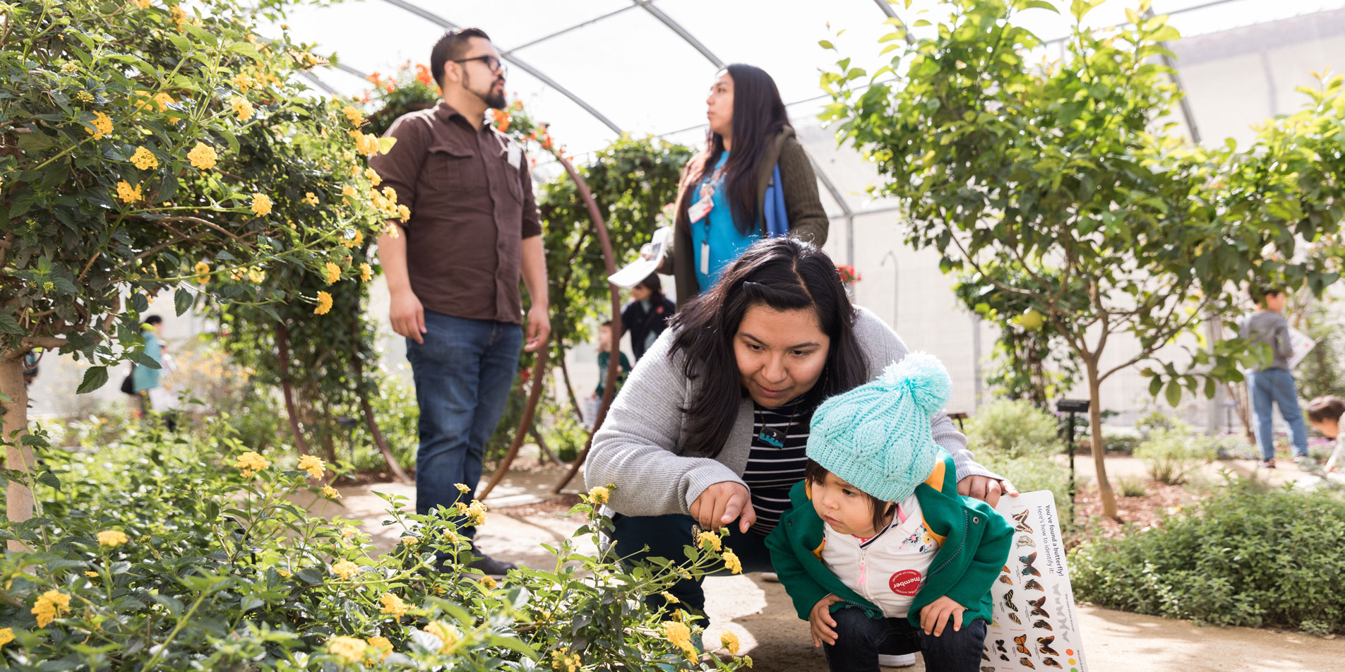 mother and child looking at flowers