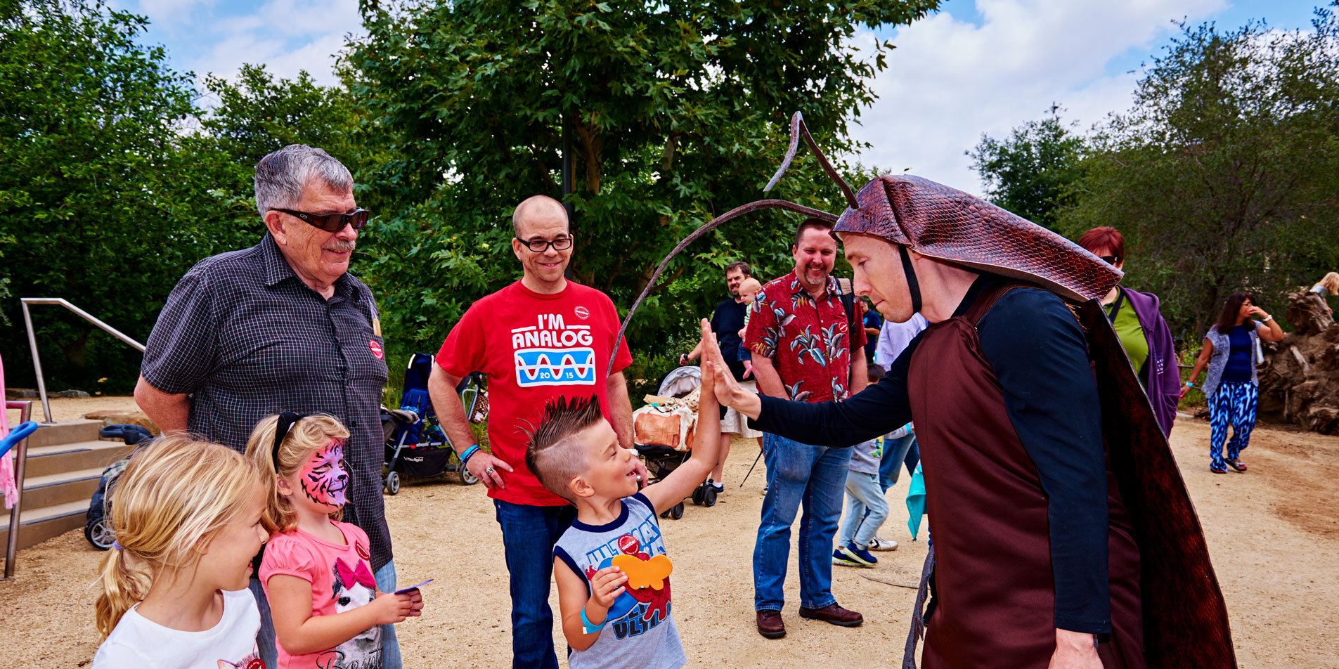 event with children and a staff in a bug costume